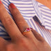Pink spinel and diamond ring on hand